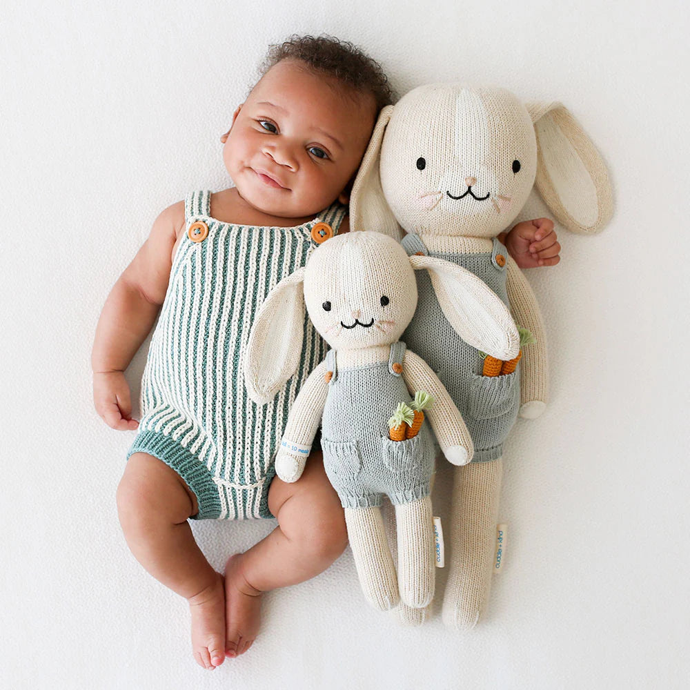 Henry the Bunny plush toy by Cuddle + Kind with soft cream fur and long floppy ears, perfect for cuddling and play.