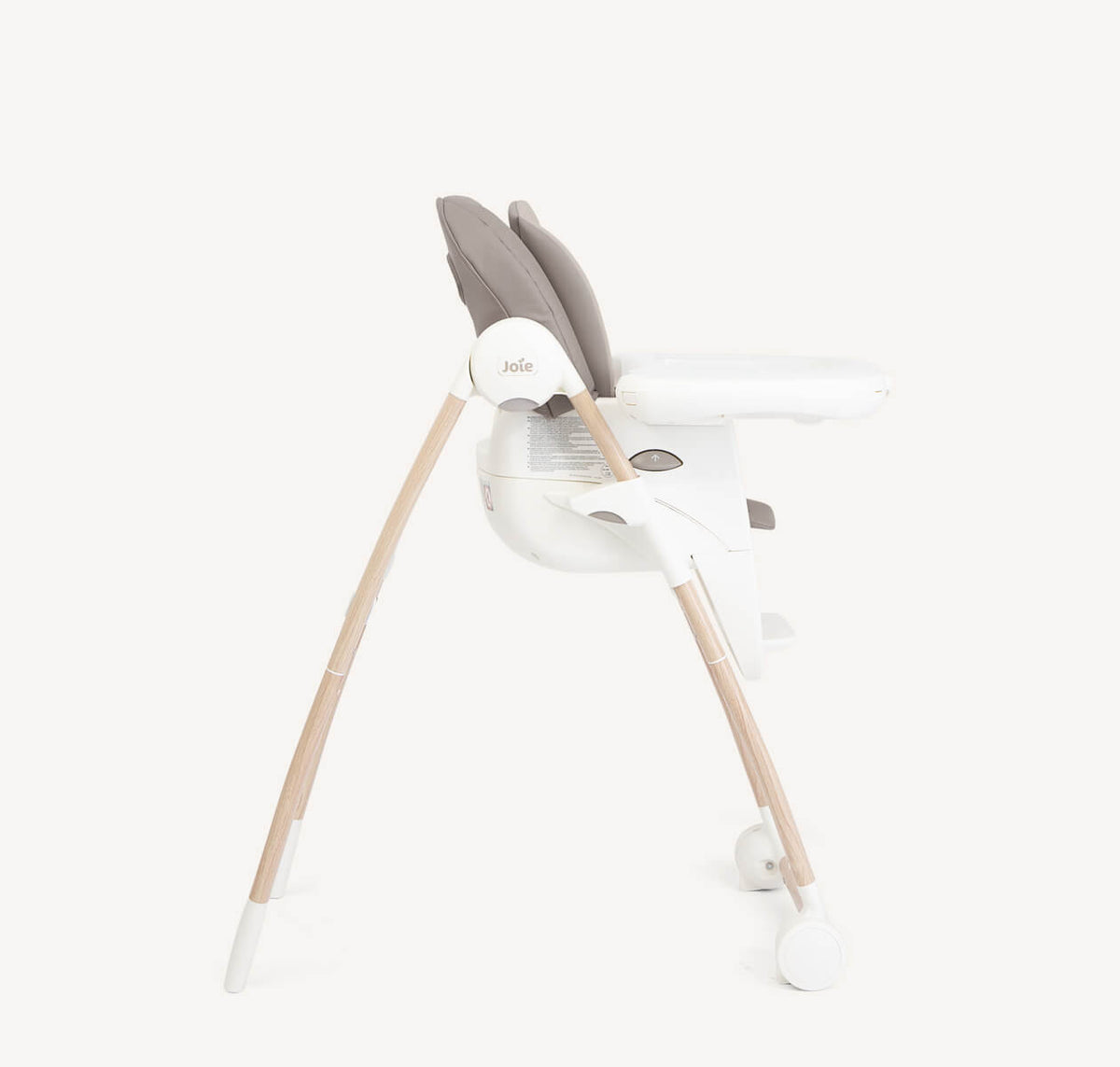 Joie Multiply 6-in-1 high chair in walnut wood with adjustable tray and safety harness, suitable for feeding and seating infants.