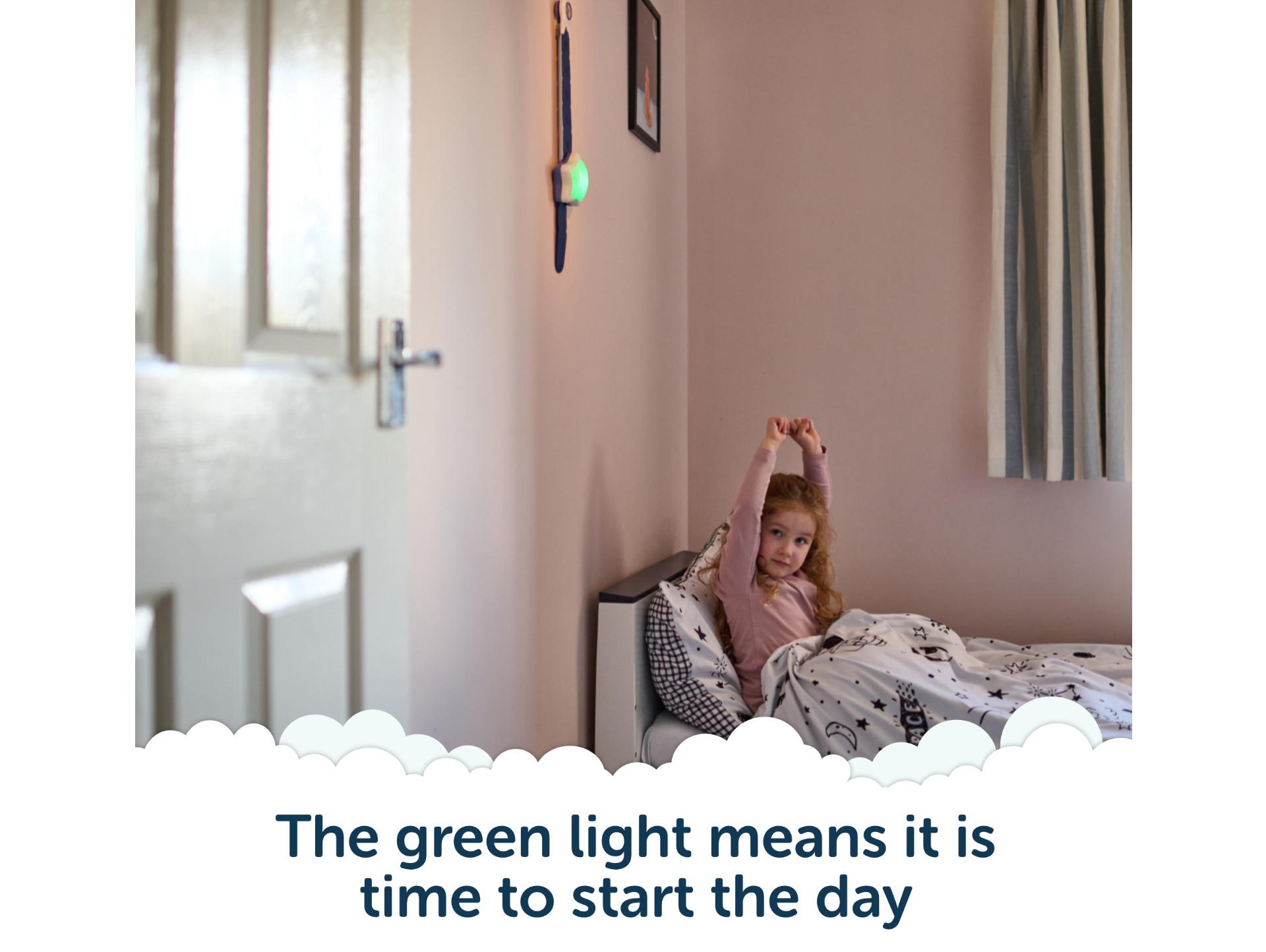 Child waking happily with Rising Star glowing green - time to start the day.