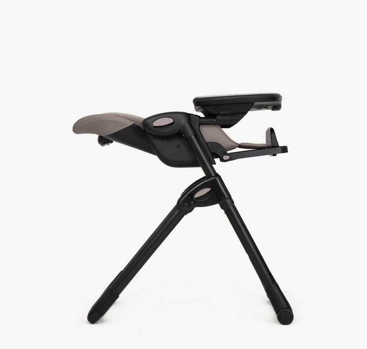 Joie Mimzy Recline high chair in Hazelnut color, shown in profile with reclined seat and adjustable features for from-birth use.
