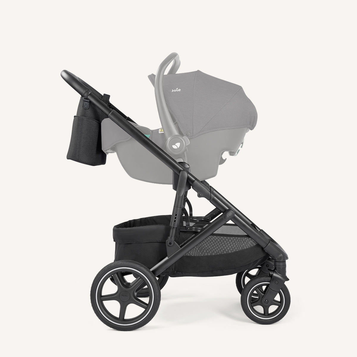 Joie Elara all-suspension stroller in Raven with infant car seat and attached bag, designed for smooth, comfortable rides.