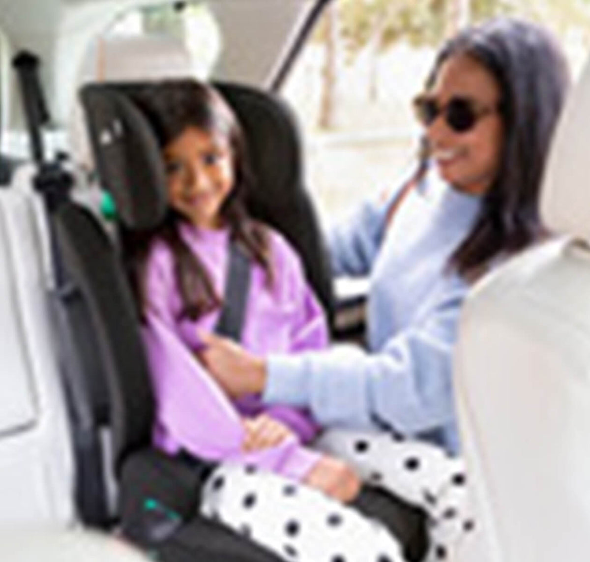 Joie i-Trillo i-Size booster car seat in Shale with a child buckled in, designed for safety and comfort during car travel.
