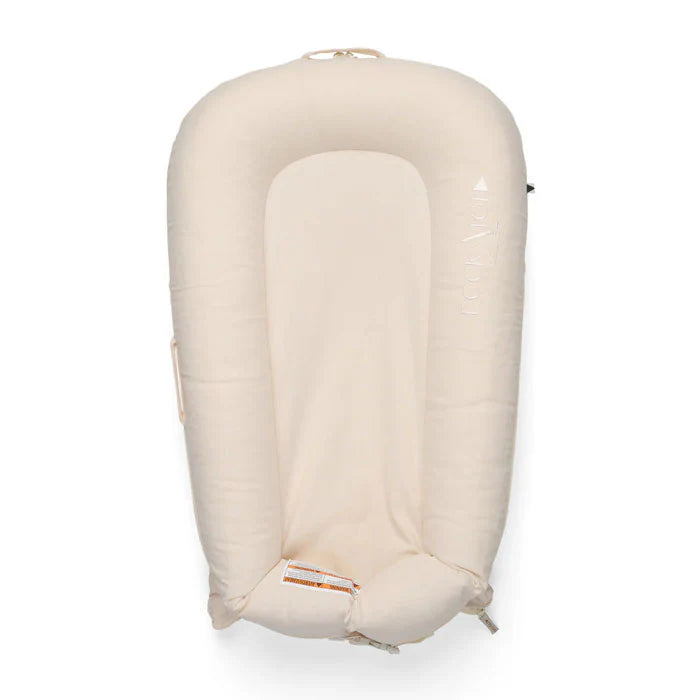 Baby Dock Deluxe+ Dock in Sand Chambray by Dock-A-Tot, showing soft fabric and cozy design for infants ages 0-8 months.