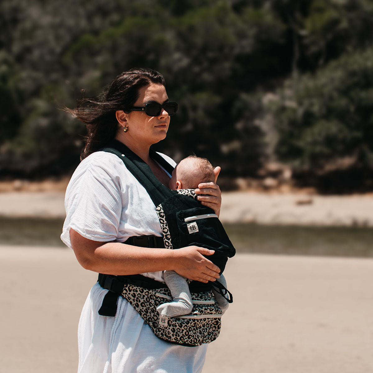 Side view of the Ubuntu Baba Stage 1 Wildling baby carrier worn outdoors