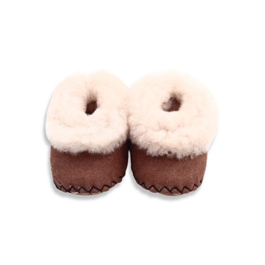 Brown Snuggly Slippers Newborn babies deserve warmth and comfort and these sheep skin wool booties will keep your baby’s feet warm in the cutest possible way. A great baby shower gift, these tiny slippers are sized for newborn babies and feature a soft leather sole to protect ankles. Brown Snuggly Slippers Newborn babies deserve warmth and comfort and these sheep skin wool booties will keep your baby’s feet warm in the cutest possible way. A great baby shower gift, these tiny slippers are sized for newborn